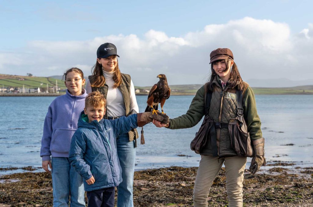 Falconry (48) A family posing with a bird near the water