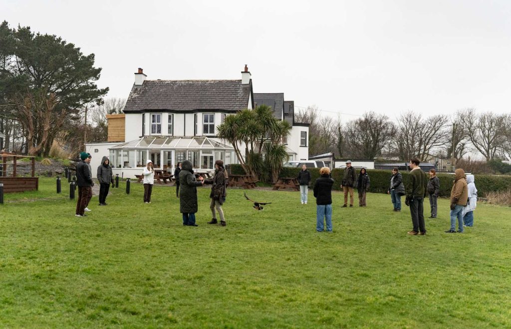A group enjoying a demonstration on a rainy day